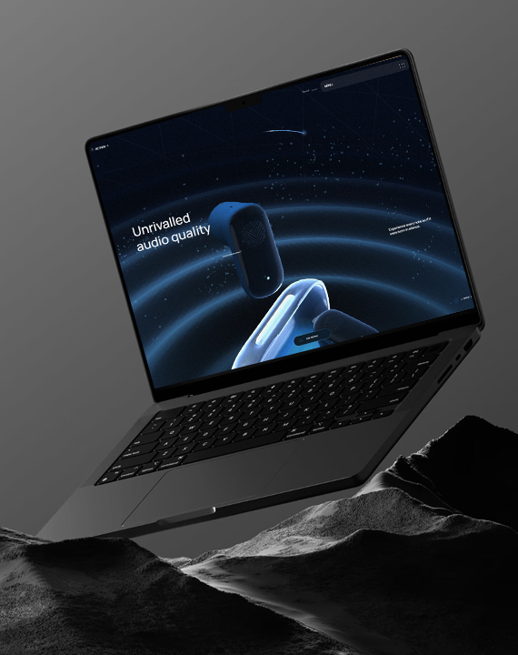 Laptop showcasing premium audio website on rocks